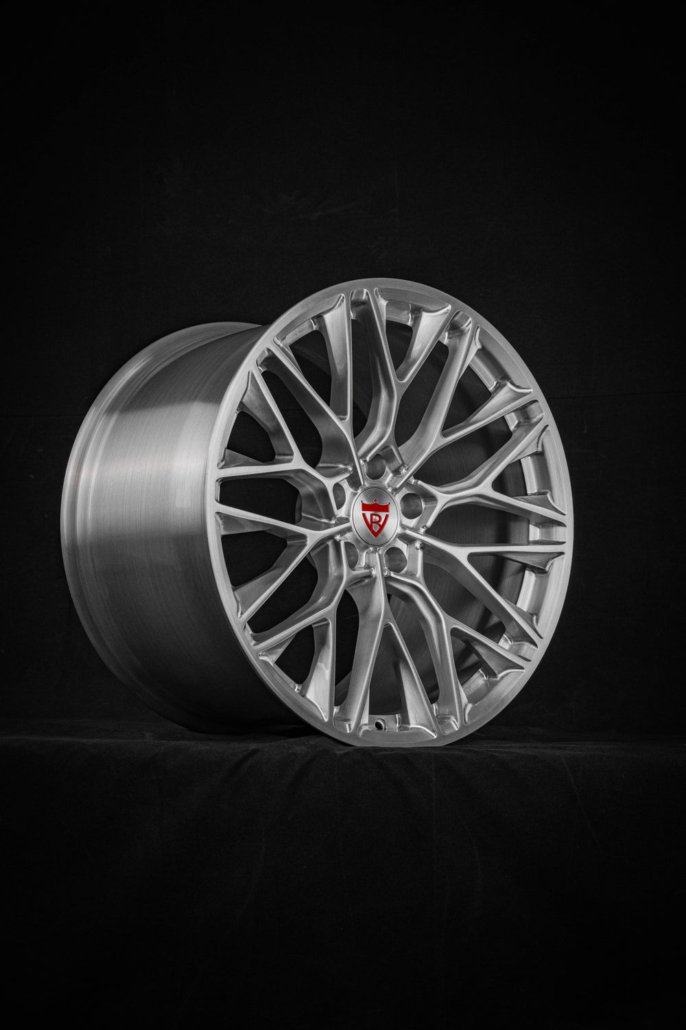 Brushed aluminum mesh seven-split-spoke RVRN RV-MP184 forged wheel standing on a dark studio floor, custom wheels for the 2016 Corvette C7 Z06