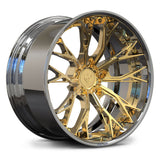 A polished gold and chrome multi-spoke alloy wheel rim, shown at a three-quarter angle on a clean white background.