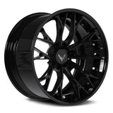 A glossy black multi-spoke aftermarket car wheel rim with a silver Corvette logo on the center cap, shown on a white background.