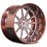 A high-polish chrome and rose gold alloy wheel rim with a multi-spoke design, featuring a red and white center cap logo, shown on a white background.