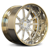 A polished gold and chrome multi-spoke alloy wheel rim, shown at a three-quarter angle on a clean white background.
