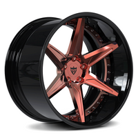 Black alloy wheel with rose gold finish on a white background