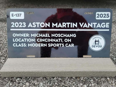 2023 Aston Martin Vantage display sign featuring owner and event details, showcasing modern sports car class.