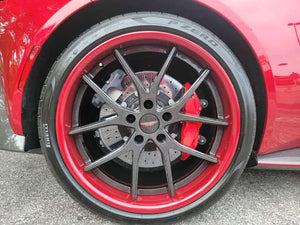 Aston Martin V8 Vantage featuring stylish RVRN wheels with carbon fiber rims and striking red accents.