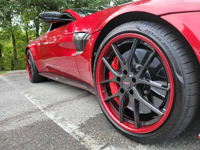 Close-up of Aston Martin V8 Vantage featuring RVRN carbon fiber rims with red accents.
