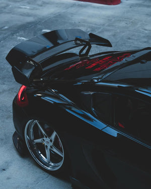 Rear three-quarter view of a 2014 Porsche Cayman widebody with RVRN RV-DP02 polished aluminum 5 spoke deep lip forged wheels.