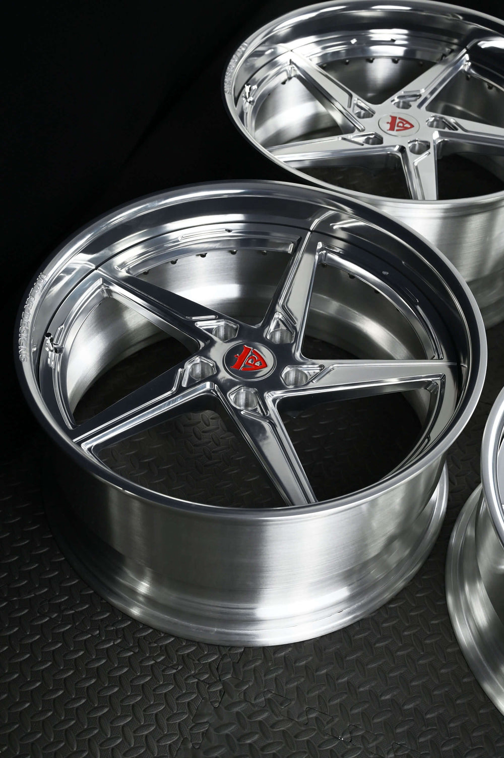 Custom forged Porsche Cayman wheels with a 5 spoke deep lip design, showcasing polished aluminum finish and high-performance style.