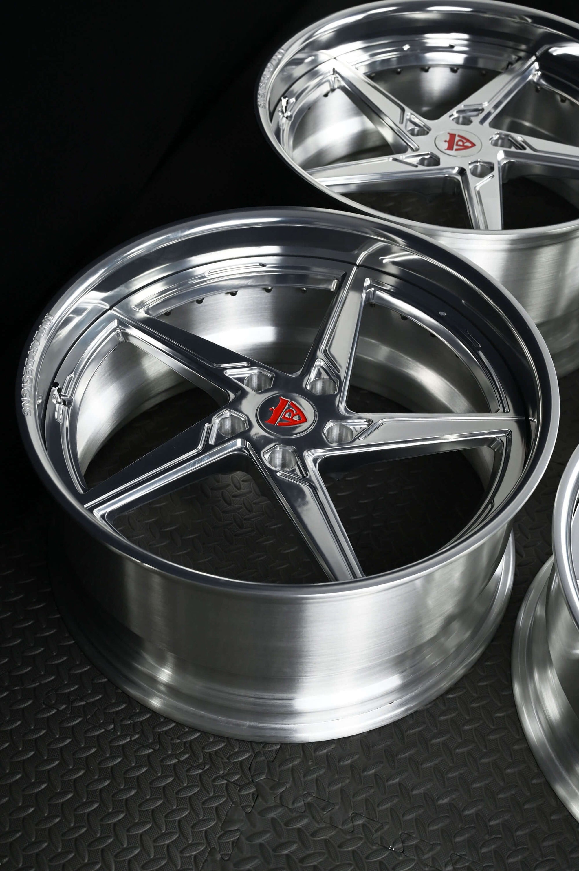 Custom forged Porsche Cayman wheels with a 5 spoke deep lip design, showcasing polished aluminum finish and high-performance style.