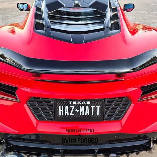 Rear view of a red Corvette C8 showcasing custom forged 5 spoke rims and sleek aerodynamic design.
