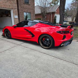 Rear three-quarter view of a red 2025 Corvette C8 Stingray on RVRN RV-DP03 wheels with bronze lips in a residential driveway
