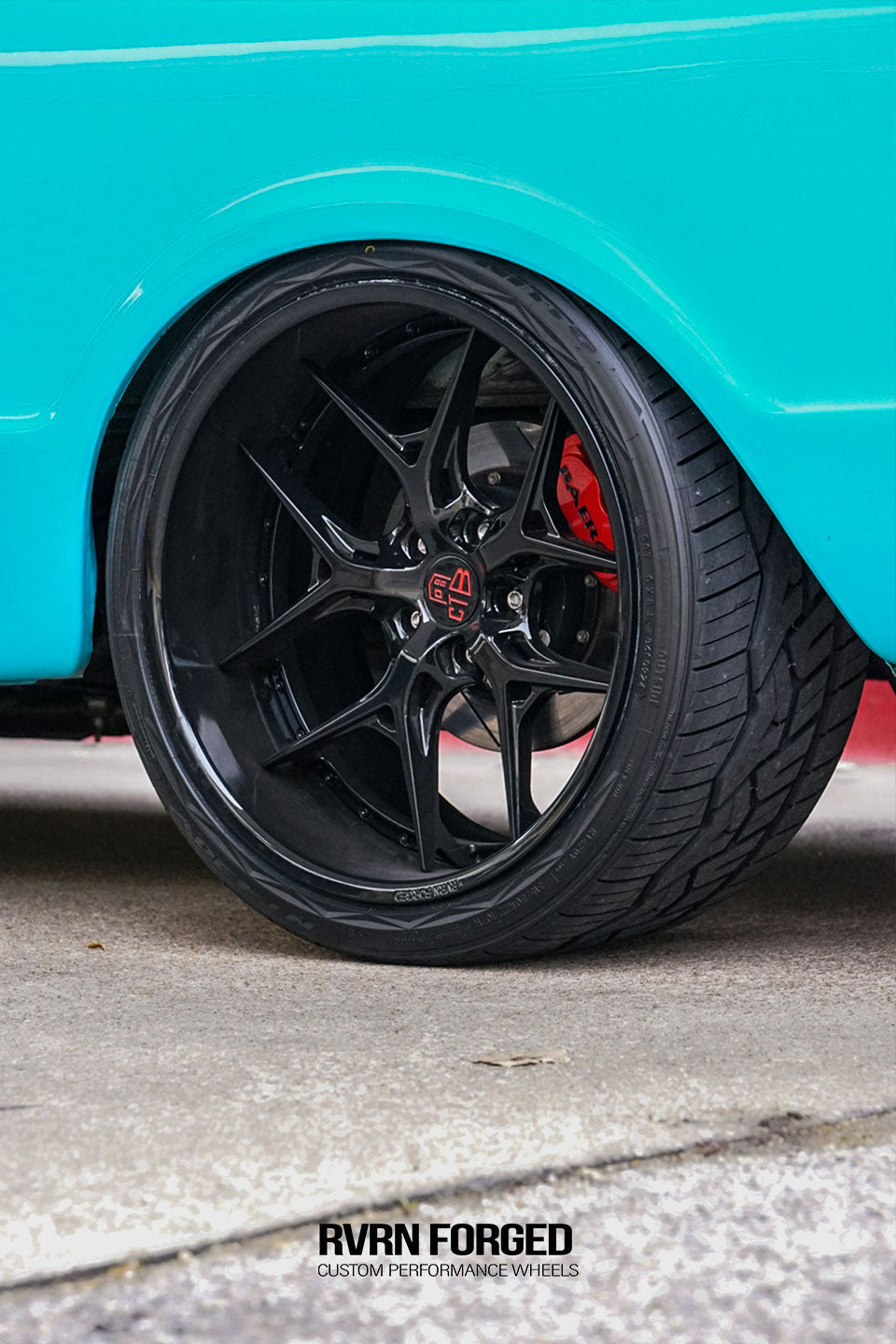 Close-up of 1984 Chevy C10 custom wheels with black deep dish rims and a 22-inch aftermarket tire.