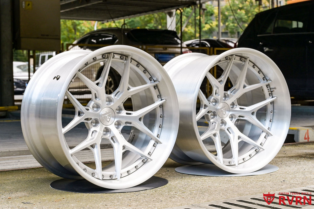 Two brushed aluminum RVRN RV-DR08D forged wheels standing side by side in the workshop, 2004 Dodge Viper