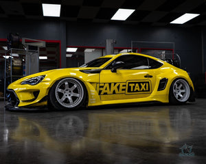 Side view of the yellow widebody 2015 Scion FRS on Pearl White RVRN RV-DS01 forged wheels, indoor show