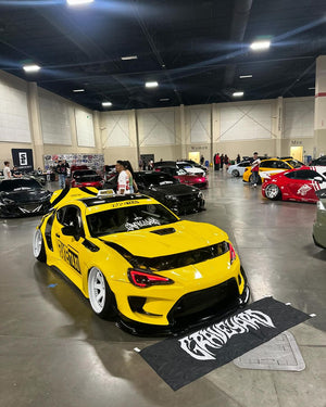Yellow widebody 2015 Scion FRS at an indoor show on Pearl White RVRN RV-DS01 forged wheels