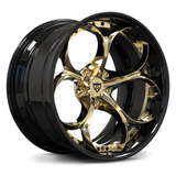 A luxury car wheel rim featuring a glossy black outer barrel and polished gold multi-spoke face, with a central shield logo badge.