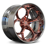 A polished chrome wheel rim with a rose gold center and spokes, featuring a shield logo on the hub, shown on a white background.