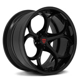 A glossy black multi-spoke alloy wheel rim with a red shield logo badge in the center, shown on a clean white background.