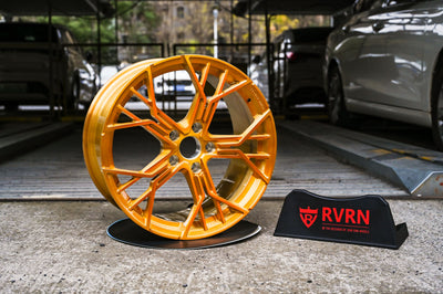 Custom forged wheels for a 2014 Corvette C7 showcasing vibrant orange finish and modern design.
