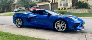 Side profile of a Riptide Blue 2024 Corvette C8 Stingray on RVRN RV-MC65 brushed aluminum forged wheels on a residential street