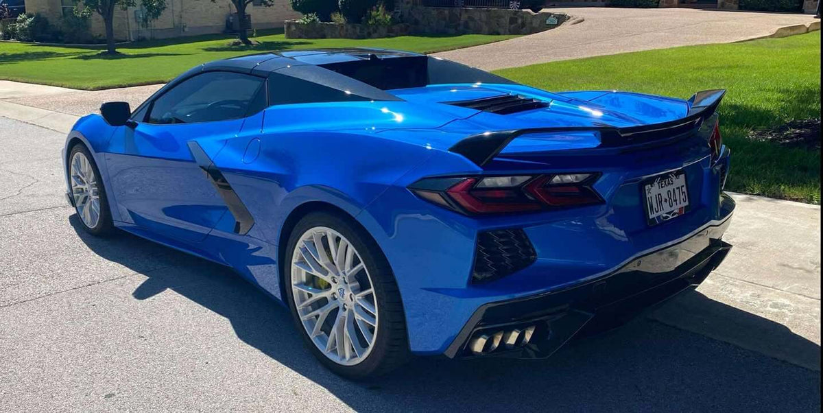 Rear three-quarter view of a Riptide Blue 2024 Corvette C8 Stingray on RVRN RV-MC65 brushed aluminum forged wheels with rear wing