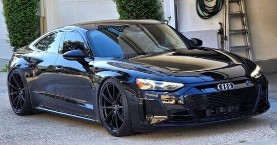 2022 Audi RS e-tron GT with sleek black concave rims and 22-inch Audi e-tron wheels parked in a driveway.