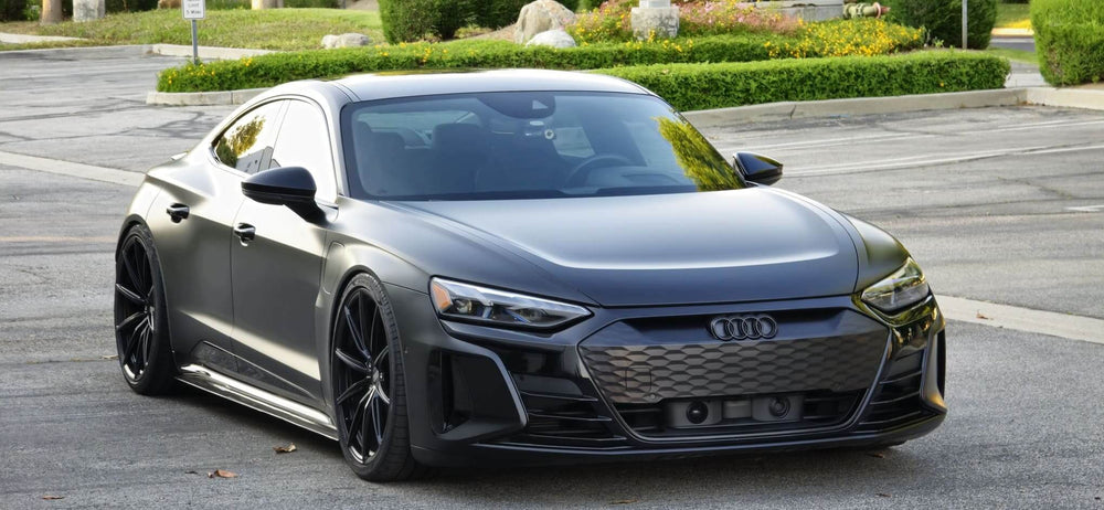 2022 Audi RS e-tron GT with sleek black concave rims and 22 inch Audi e-tron wheels parked on a street.