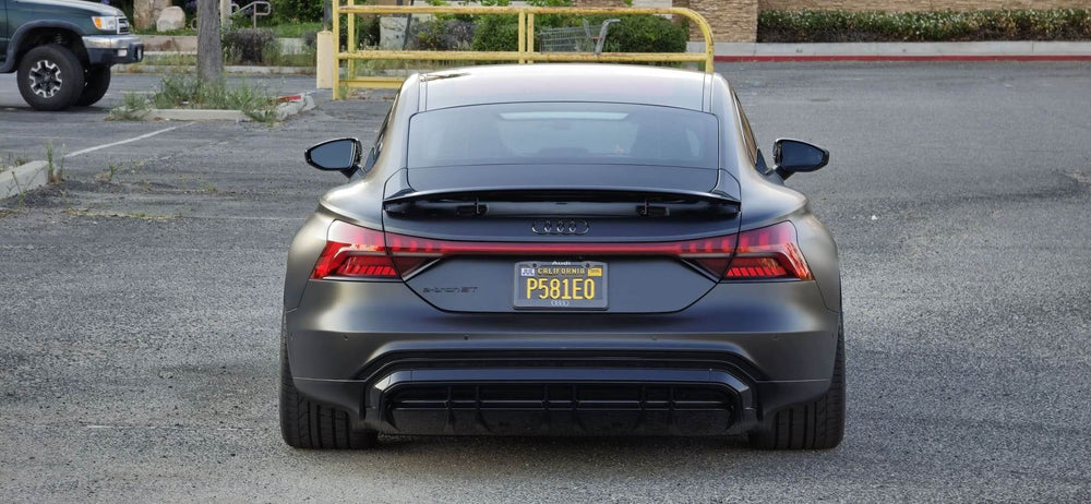 Rear view of a 2022 Audi RS e-tron GT parked, showcasing its sleek design and black concave rims.