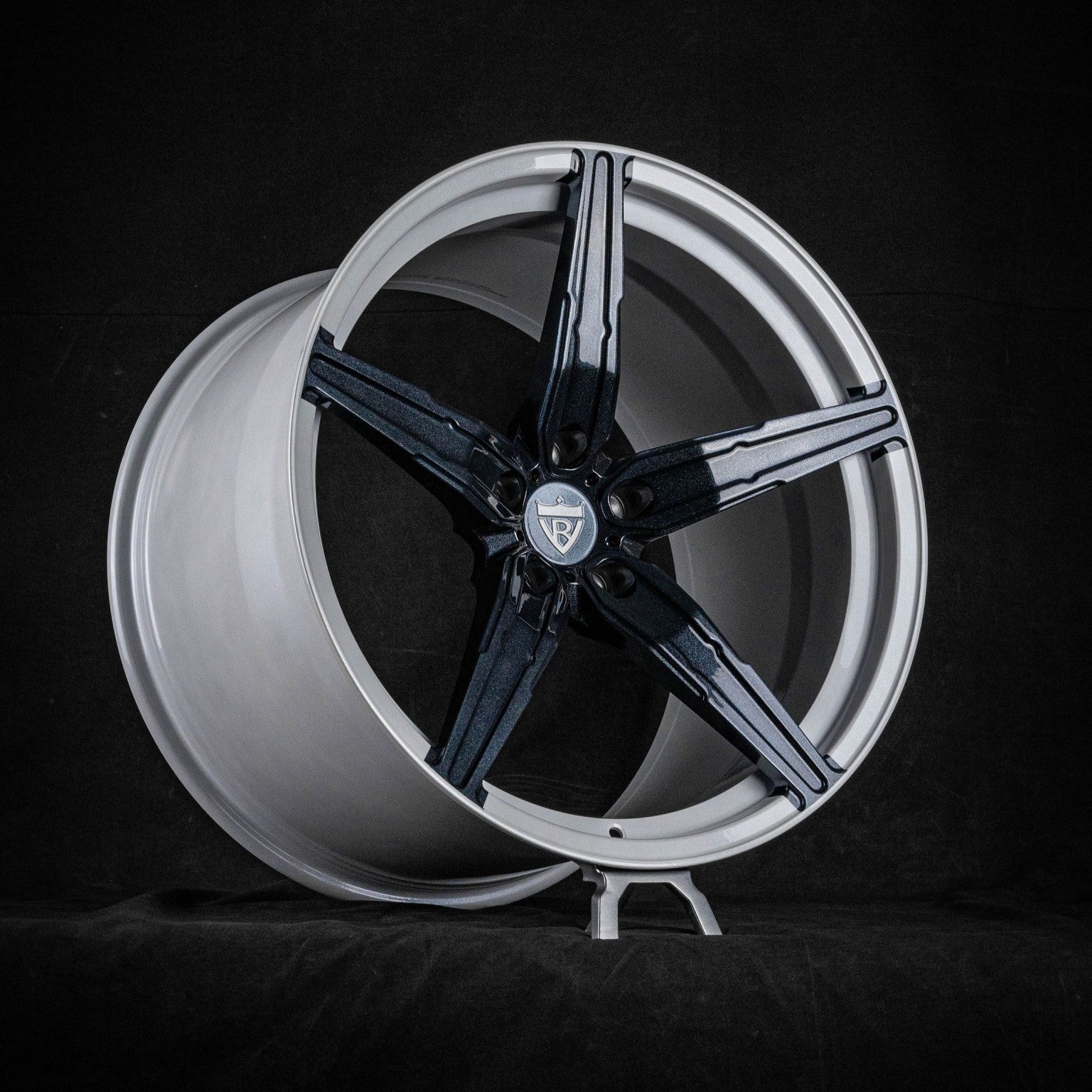 Sleek black and silver monoblock rim for Corvette C8, showcasing custom forged concave design for enhanced performance and style.
