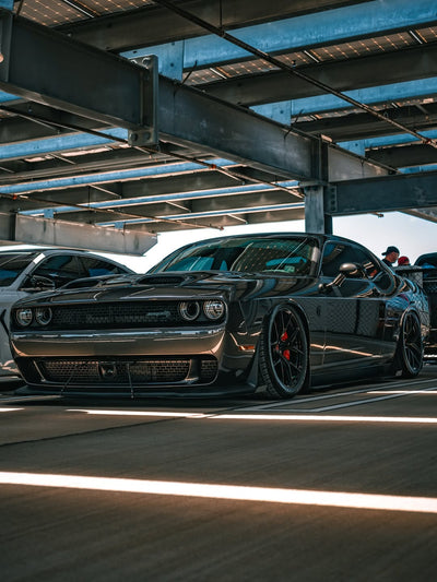 2023 Dodge Challenger Hellcat with concave 20-inch staggered custom forged rvrn wheels showcased under parking structure.