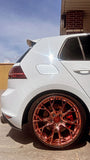 White car with custom forged monoblock wheels featuring a bronze finish.