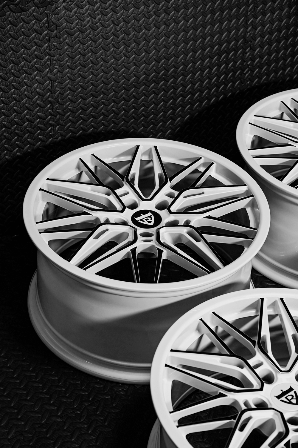 Custom forged Corvette C7 wheels featuring sleek white and black rim design, perfect for enhancing vehicle aesthetics.