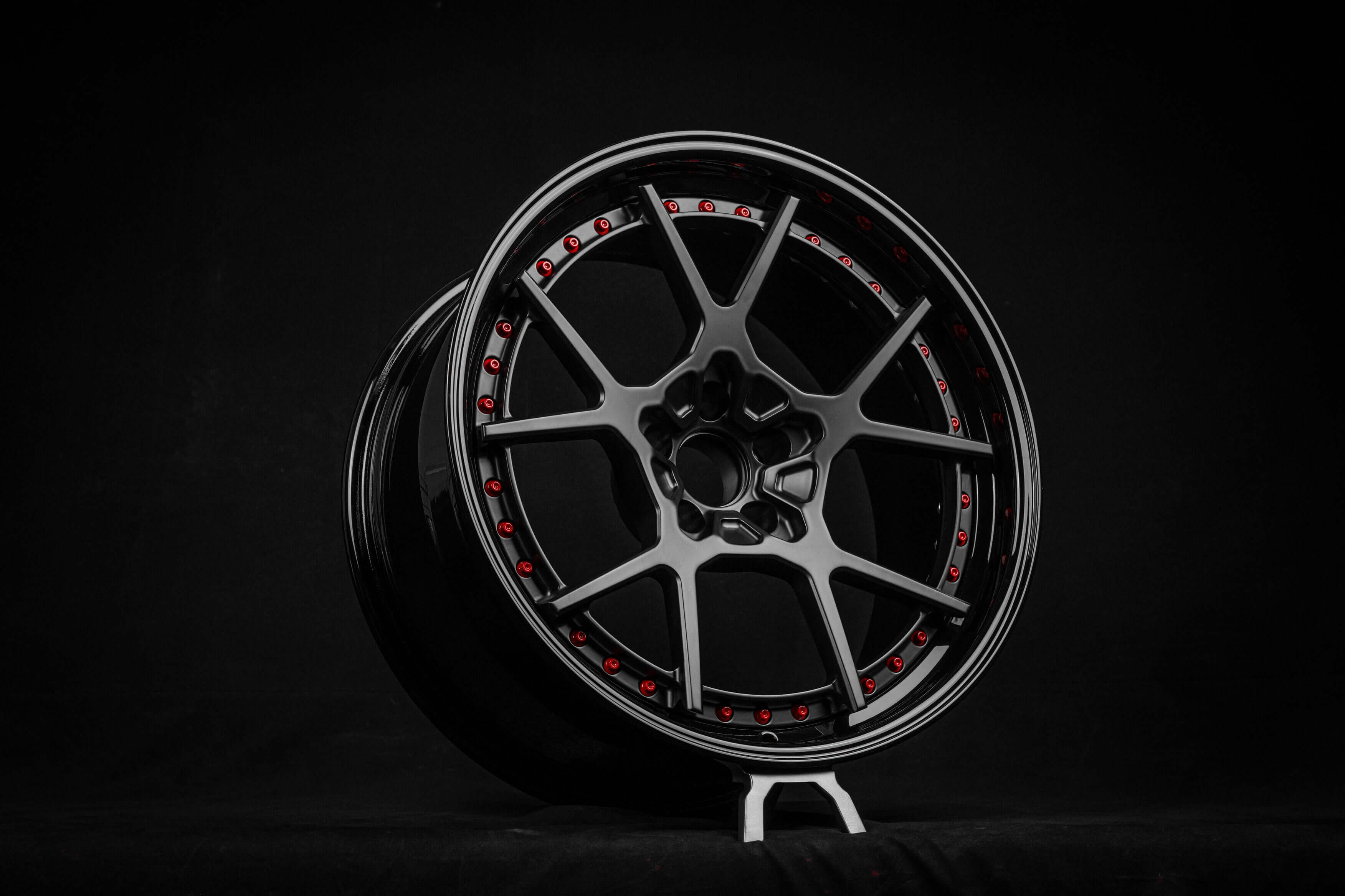 Black custom Mustang wheel with concave design and red accents, perfect for Ford Mustang enthusiasts.