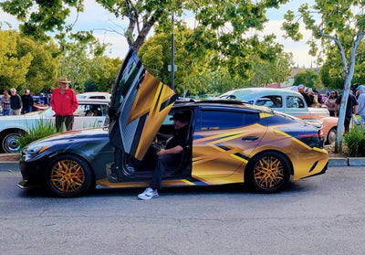 2020 Kia Stinger GT1 with RVRN custom forged deep dish wheels at car show, featuring unique door design.