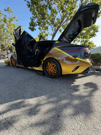 2020 Kia Stinger GT1 showcasing RVRN custom forged deep dish wheels with open doors at an outdoor event.