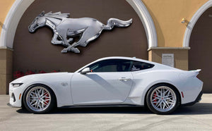 Side profile of a white 2024 Ford Mustang GT on RVRN RV-T081 deep dish wheels with pearl white spokes under a chrome Mustang emblem