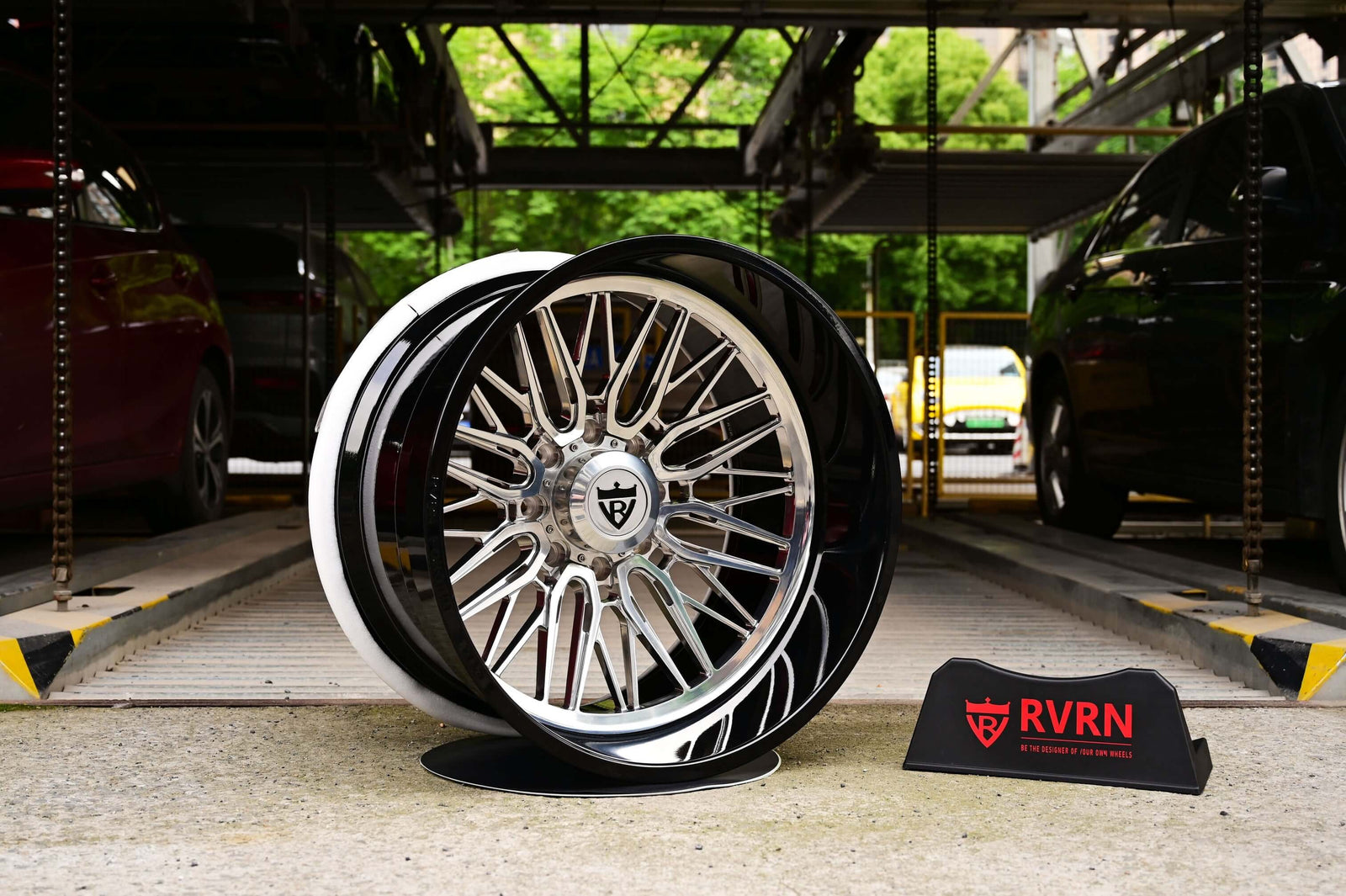 Stylish GMC Sierra custom wheels on display, featuring 24 inch deep lip rims and a sleek black and chrome design.