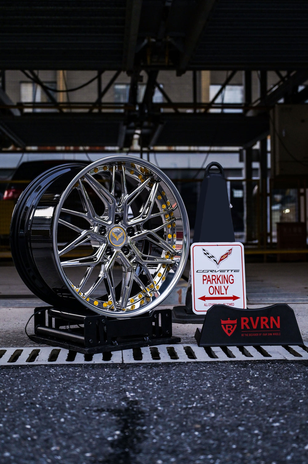Chrome Corvette C7 deep dish wheels displayed next to a Corvette-only parking sign.