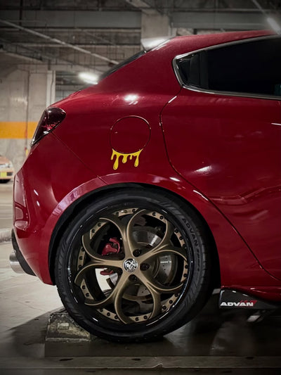 2013 Alfa Romeo featuring RVRN custom forged bronze and black rims with unique design in a modern parking garage.