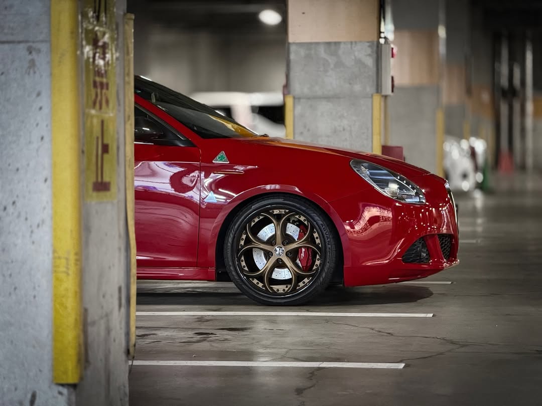 2013 Alfa Romeo with RVRN custom forged bronze and black rims in a parking garage.