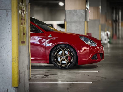 2013 Alfa Romeo with RVRN custom forged bronze and black rims in a parking garage.
