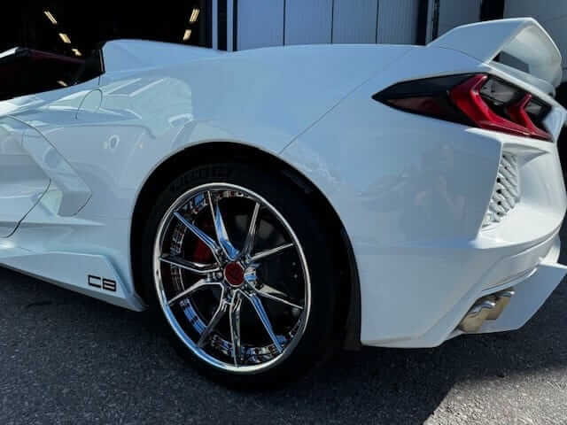 Side view of 2021 Corvette C8 Stingray showing DB082 deep concave wheels in chrome red, highlighting aggressive stance and precise fitment.