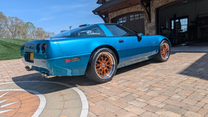 Custom Corvette C4 with RVRN custom forged wheels, showcasing vibrant blue paint and striking orange accents.