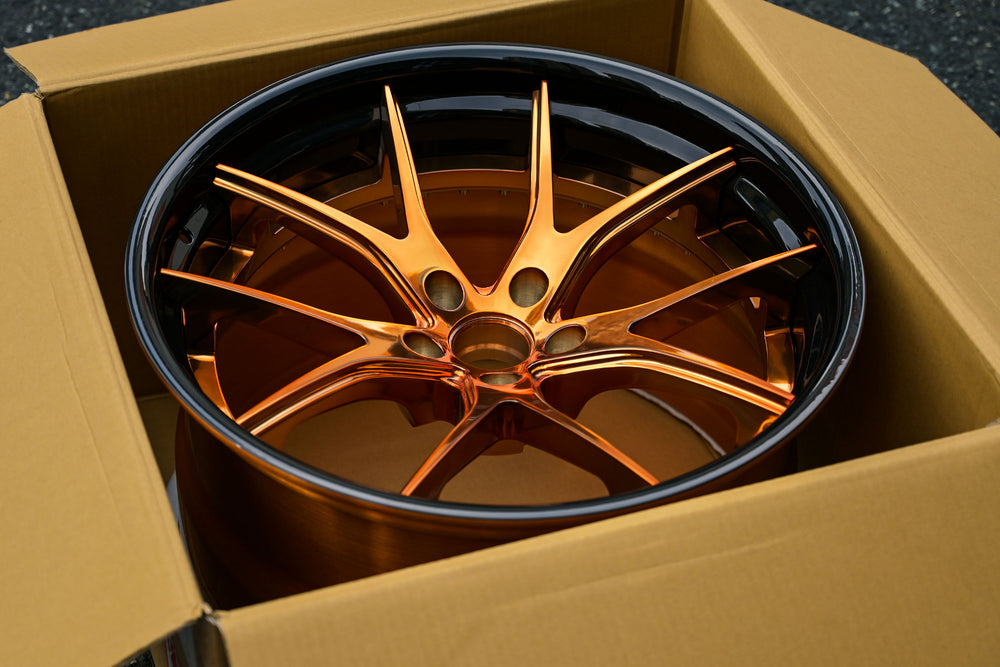 C8 Corvette bronze aftermarket wheels in a cardboard box, ideal for custom C8 Corvette upgrades and performance.