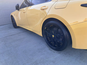 Detailed view of the RVRN RV-DC24 gloss black wheel and yellow screws on a yellow 2025 Lexus IS500 Performance Premium
