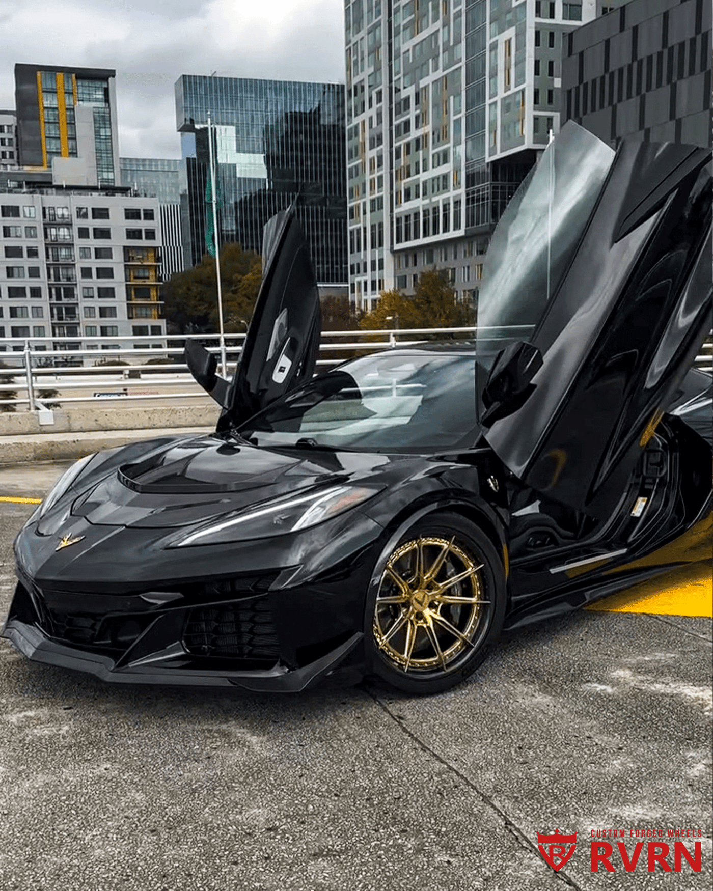 Black 2025 Corvette C8 E-Ray on RVRN gold carbon fiber wheels 20x10 front 21x13 rear flush fitment