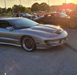 Front view of a silver 2002 Pontiac Trans Am on RVRN RV-DC56 deep dish custom forged wheels at a golden-hour car meet