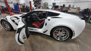 2017 C7 Corvette Grand Sport with aftermarket wheels, showcasing red interior and sleek design.