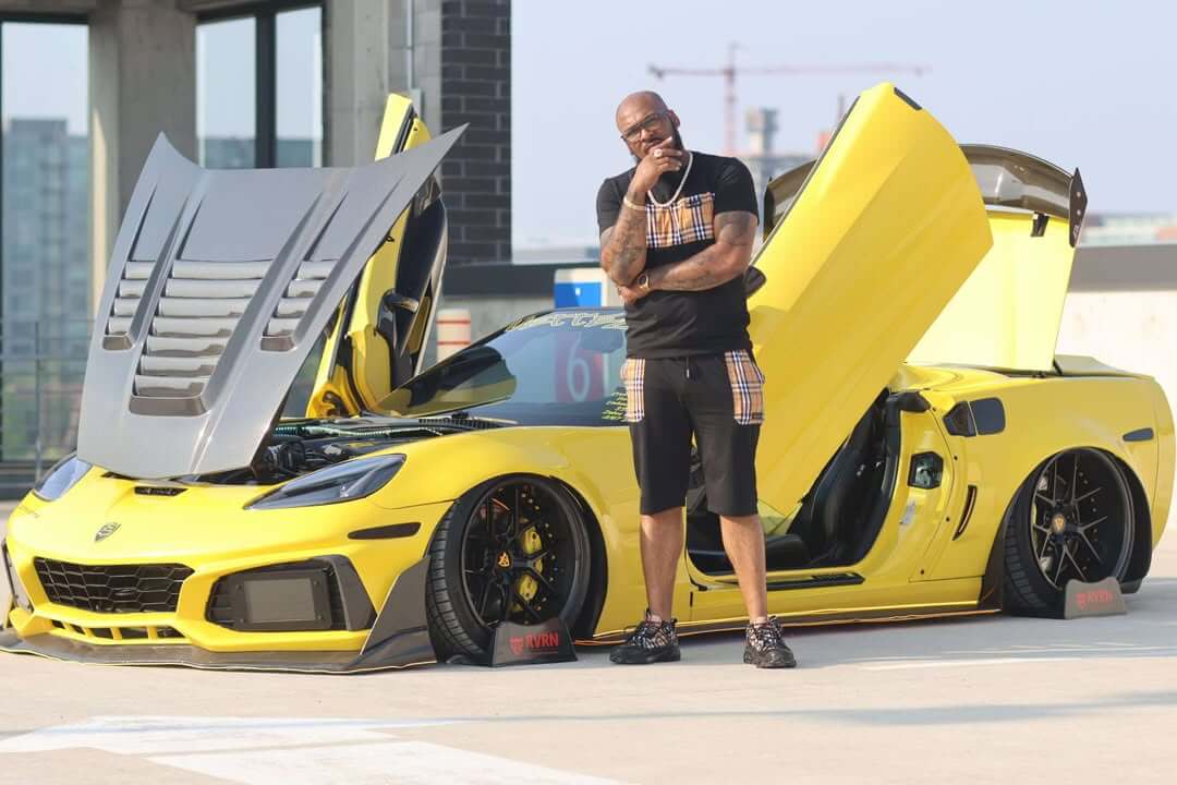 Front three-quarter view of a yellow widebody Corvette with butterfly doors open on RVRN RV-DR08D gloss black custom forged wheels