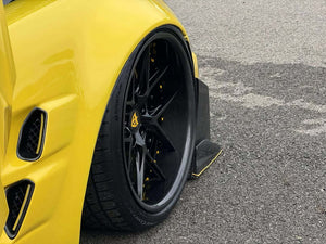 Close-up of the RVRN RV-DR08D gloss black forged wheel with carbon fiber barrel and yellow caliper on a yellow Corvette, wet pavement