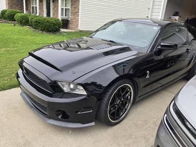 2011 Ford Shelby GT500 with custom forged black and chrome RVRN RV-DR08D wheels parked in a driveway.